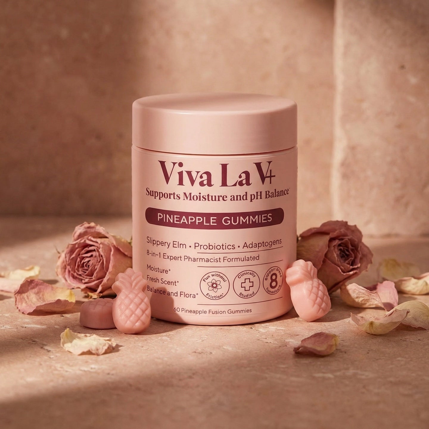 Viva La V vaginal health gummies on a blush bathroom vanity with dried roses and warm candlelight