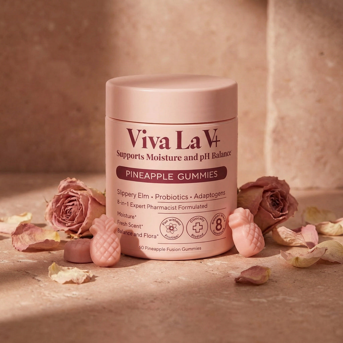Viva La V vaginal health gummies on a blush bathroom vanity with dried roses and warm candlelight